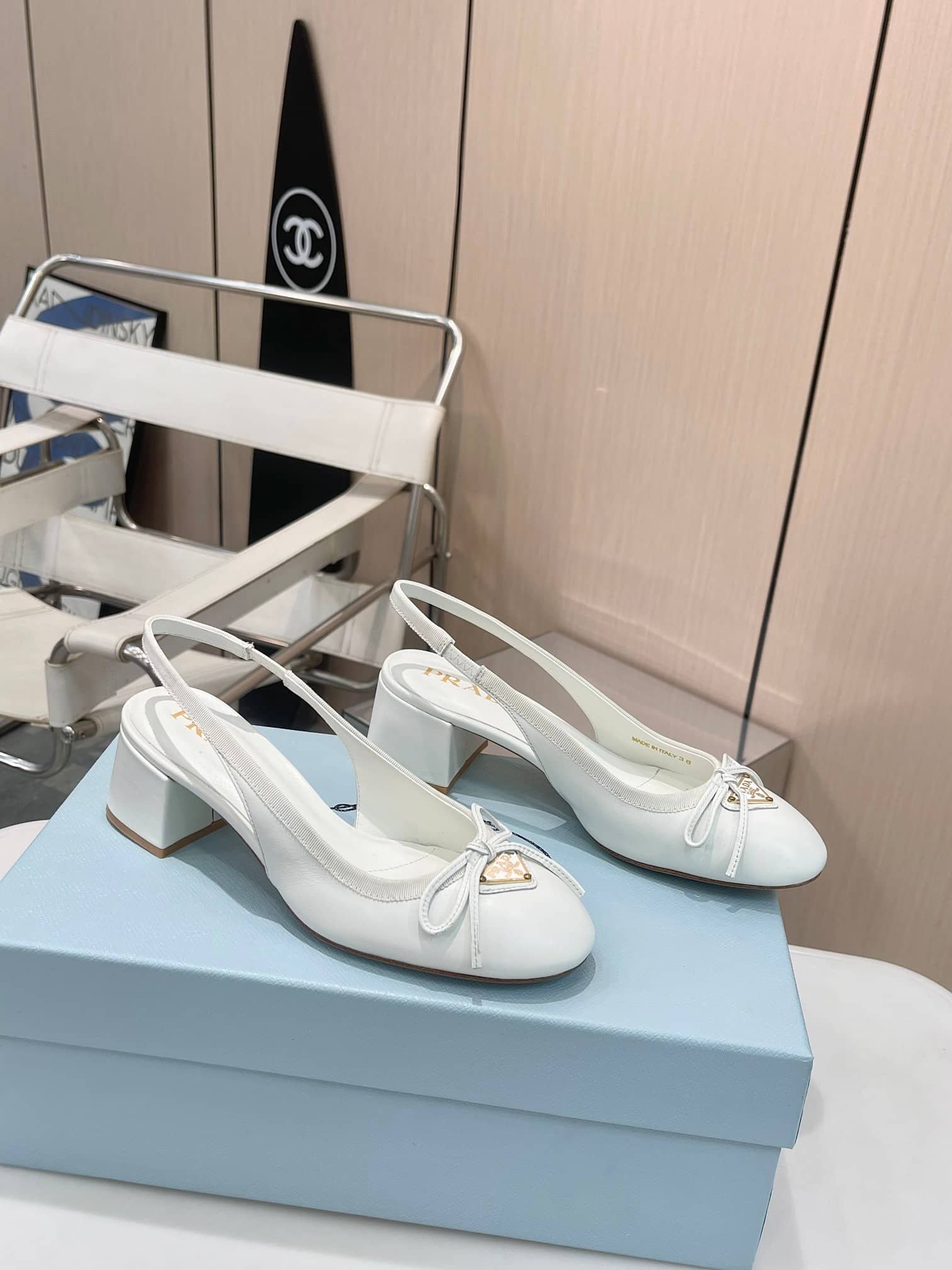 Pra*a Triangle Logo Bow Slingback Pump In White